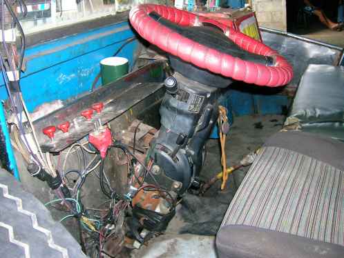 A weird wired cockpit of a jeepney, but it works.
